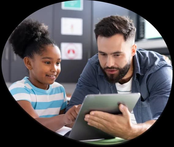 A teacher and a student looking at a tablet together